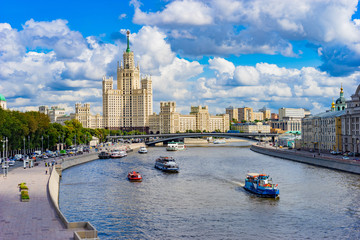 Moscow. Russia. High-rise building on Kotelnicheskaya embankment. Pleasure ships on the Moscow river. View of the capital of Russia on a cloudy summer day. Travelling to Moscow.