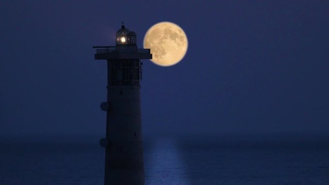 Lighthouse with full moon on Fuerteventura, Spain