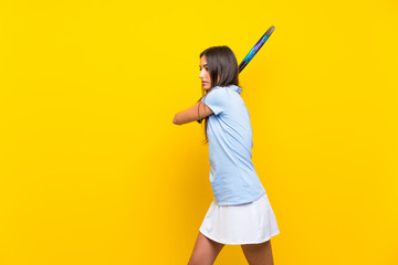 Fototapeta na wymiar Young tennis player woman over isolated yellow wall