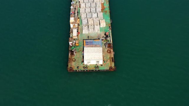 Aerial footage over barge with construction materials Drone view over Large barge with construction materials in Mediterranean sea new Harbor