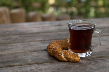 a glass of tea on the wooden background.