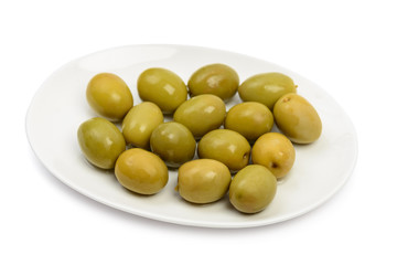 Plate with wet green olives isolated