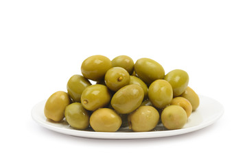 Plate with wet green olives isolated