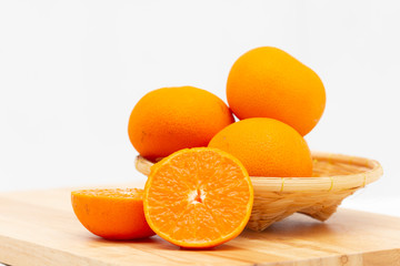 Fototapeta na wymiar Orange slice in a basket on wooden background,