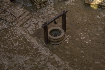 Old Medieval Draw Well in Cobblestone Yard