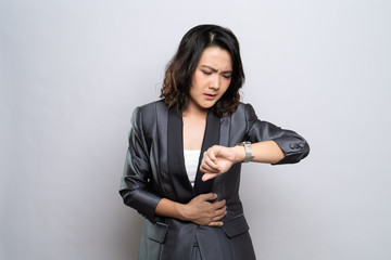 Businesswoman has stomach ache isolated over white background