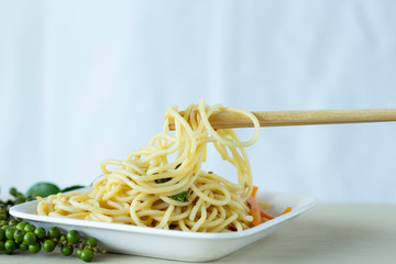 Spaghetti lines on chopsticks with white background,