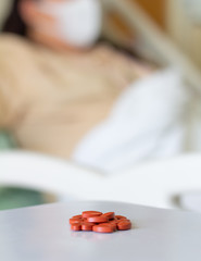 red medicine on blurred patient background