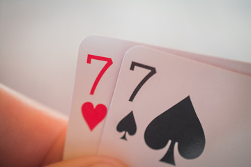 Double seven, Playing cards in hand on the table, poker nands
