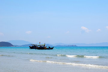 Vietnamese boat is on the sea. Beautiful tourist background.