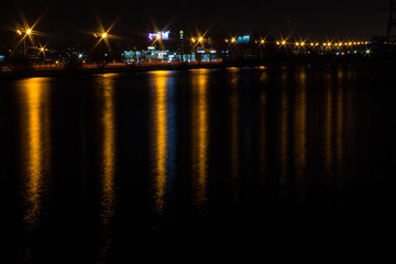Fototapeta na wymiar night city with lanterns and reflection in water