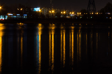 night city with lanterns and reflection in water