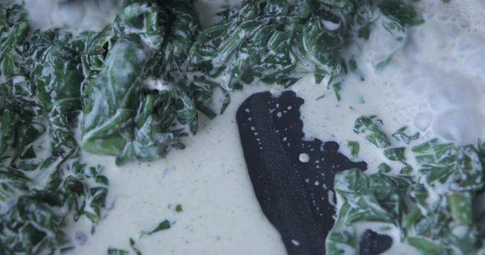 Сooking spinach in frying pan