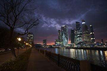 Moscow city after sunset on a background of purple sky with pink clouds