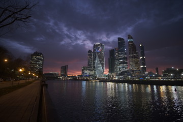 Moscow city after sunset on a background of purple sky with pink clouds
