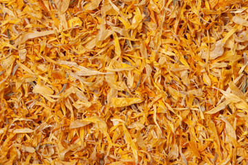 Dried calendula petals yellow flowers above view macro