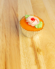 Beautiful Cupcake on wooden pattern background