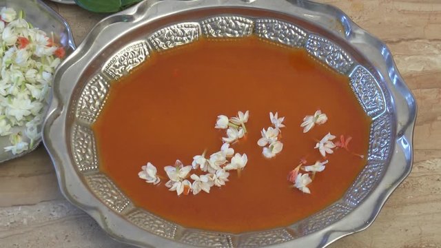 Traditional Indian Aarti / coloured water on plate with flowers 