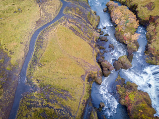 View from flying drone. Splendid morning view of nameless waterfall. Fresh green hills on the southern coast of Iceland . Beauty of nature concept background..