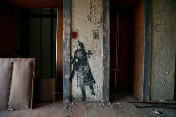 interior of an abandoned apartment building and elevator doors with the silhouette of a little girl trying to call an elevator in the Chernobyl exclusion zone