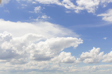 Fototapeta premium White cumulus clouds in blue sky at daytime. Natural background photo texture