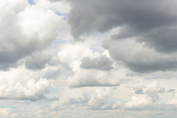 Fototapeta na wymiar White cumulus clouds in blue sky at daytime. Natural background photo texture