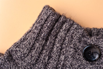 Close-up fragment of a gray knitted warm jacket