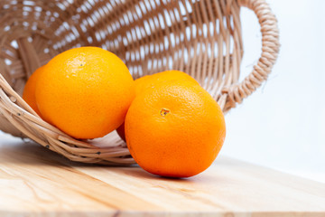 Orange slice in a basket on wooden background,