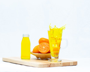 Yellow orange juice in the glasses and bottle on white background,