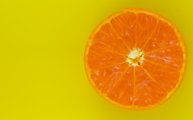 Orange in yellow colour paper background,