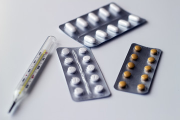 Different tablets, pills in foil blister packs, medications drugs on white background - 298636723