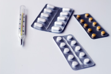 Different tablets, pills in foil blister packs, medications drugs on white background - 298636739
