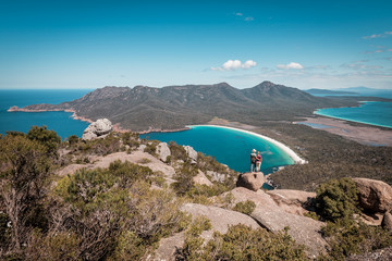 View from Mount Amos to the spectacular Wineglass Bay, white sandy beach and turquoise blue water, Freycinet National Park, Coles Bay, Tasmania, Australia