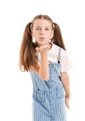 Cute little girl blowing kiss on white background