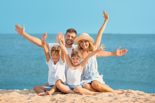Portrait of happy family on sea beach