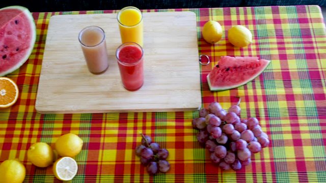 Colorful assortment of fresh fruits : orange, lemon, watermelon and grapefruit. Cinematic 4K shot with soft movement of fruit platter containing