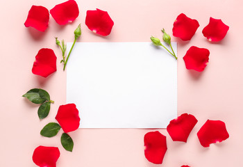 Blank card and beautiful rose petals on color background