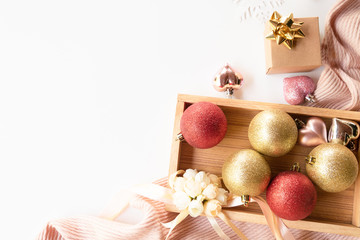 Christmas composition. Christmas balls and gift box decorations on knit background. Christmas, winter, new year concept. Flat lay, top view, copy space.