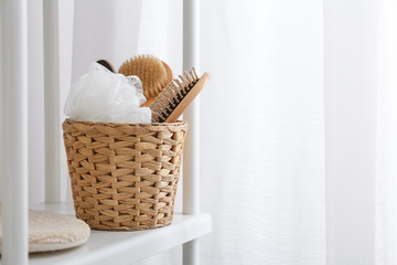 Basket with accessories on shelf in bathroom