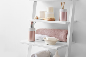 Body care cosmetics with accessories on shelves in bathroom