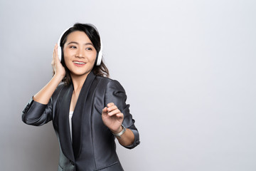 Happy woman with headphones and listening to music isolated on white background