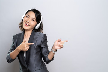 Happy woman with headphones and listening to music isolated on white background