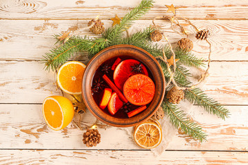 Christmas composition with mulled wine and fresh oranges on wooden background