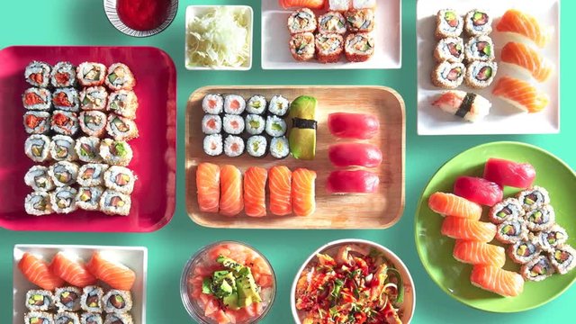 Assortment of trays and plate of sushi and maki
