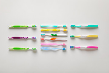 Set of tooth brushes on light background