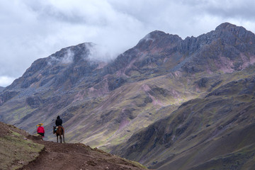 Fototapeta premium Horse driver and tourist are going to the Rainbow Mountains (Peru)