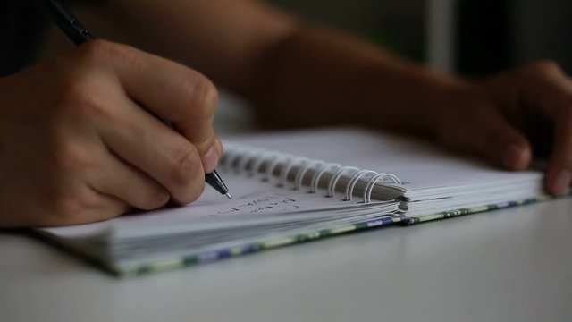 Hands wresting the sheet of paper and making paper ball after mistake during writing. Footage.