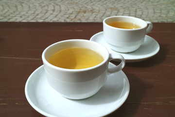 Pair of herb tea served on the wooden table
