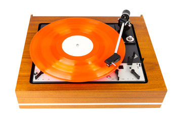 Vintage turntable with a red vinyl isolated on white