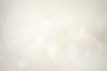 Obraz premium abstract blur white bokeh circles on golden background.